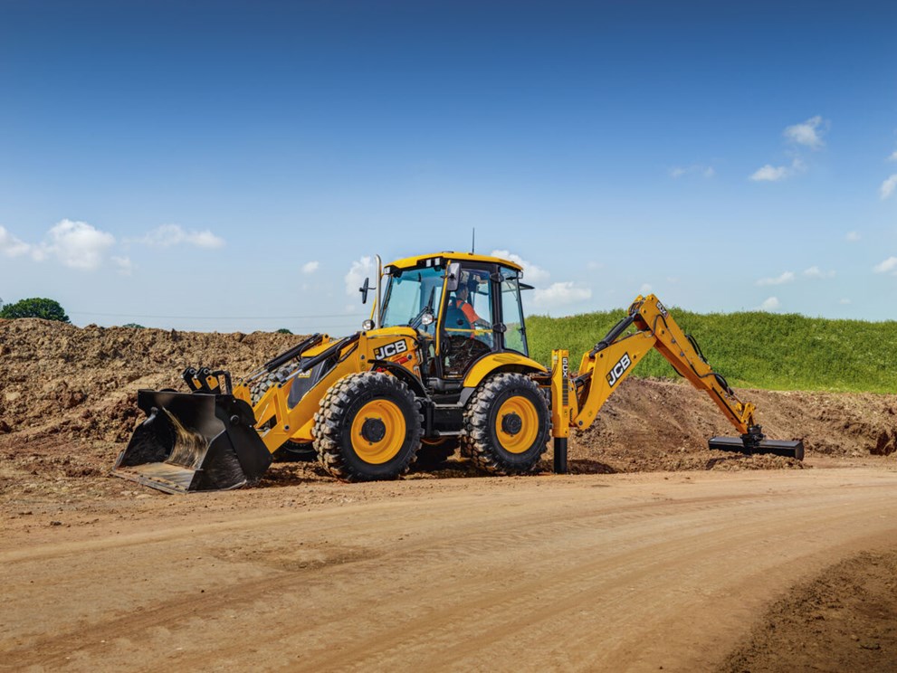 A 5CX Backhoe loader excavating on a dirt path